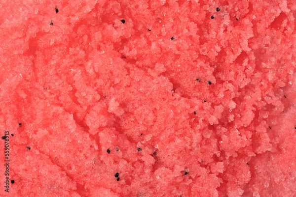 Fototapeta Sugar or salt body scrub texture. Pink red scrub - skin care product with fruit extract as cosmetic background with copy space. Macro photo