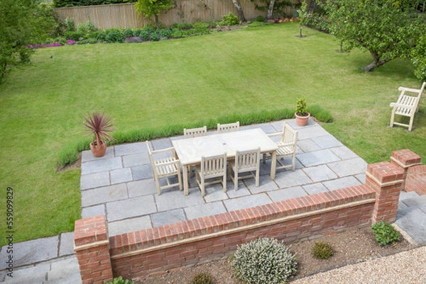 Fototapeta Large UK back garden with patio furniture on terrace