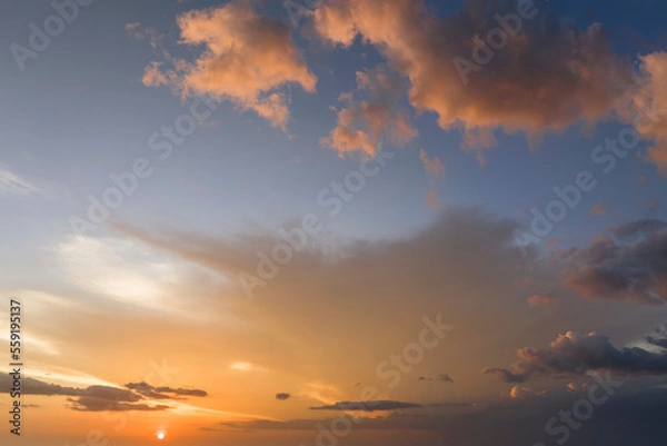 Fototapeta Colorful evening landscape with soft pastel coloured cloudscape on watercolor tinted sunset sky. Abstract nature background