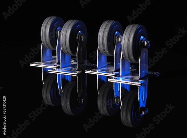 Obraz Rubber wheels in a metal frame on a black background with a reflection on the table