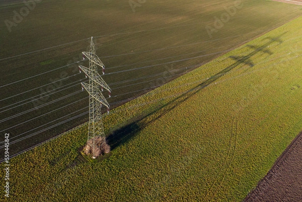 Obraz Power supply pole on farmland with powerlines and cables