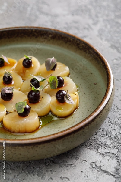 Fototapeta Scalops in sauce served with fresh berries on top. Food in restaurant.