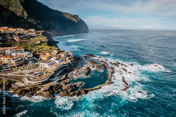 Fototapeta Aerial view of Porto Moniz with volcanic lava swimming pools,Madeira.Saltwater natural pools created in lava formations by Atlantic ocean.Gorgeous views,relaxation,crystal-clear water.