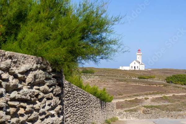 Obraz Poulains lighthouse on the hill with stone rustic wall on the foreground in Brittany, France
