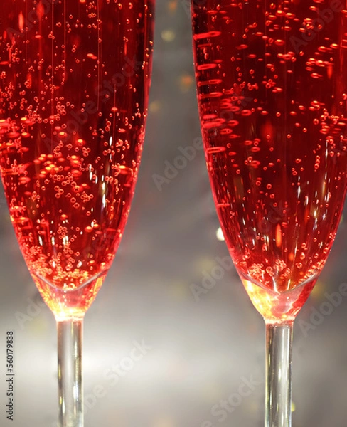 Fototapeta Two glasses with red carbonated drink close-up, abstract idea
