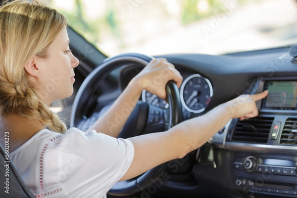 Fototapeta woman setting vehicle navigation system
