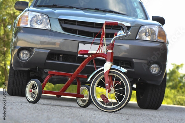 Obraz Child's Tricycle in front of SUV