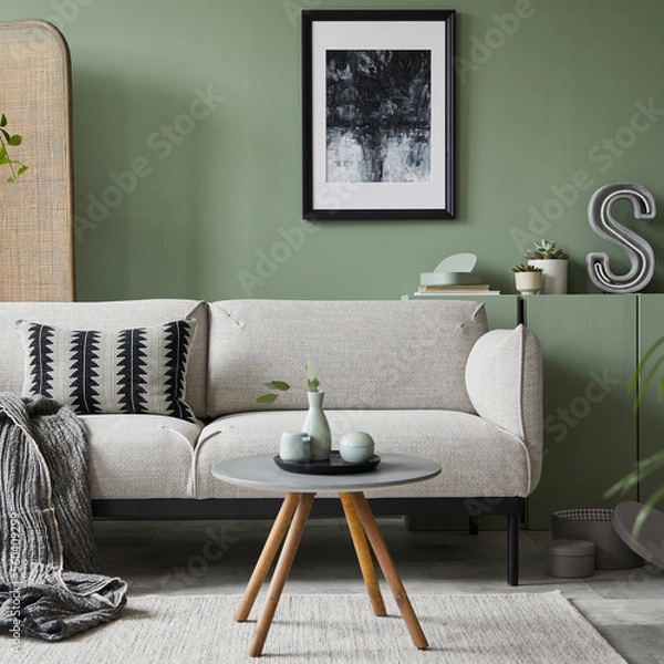 Fototapeta Elegant living room interior design with mockup poster frame, modern grey sofa, wooden commode, folding screen, plants and stylish accessories. Eucalyptus wall. Template. Copy space.