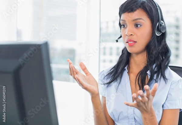 Fototapeta Confused operator looking at her computer