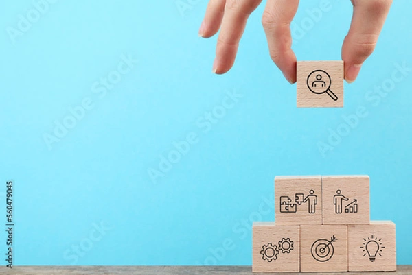 Fototapeta Hire Team Job Concept, Looking for you, Outstanding talent stand out from the crowd and different, Background, Step by step, Business, Hand holding wood cube, blue copy space