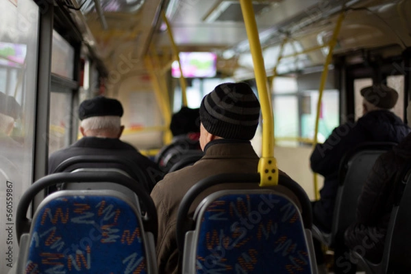 Obraz People on bus. Seating on public transport. Seats in interior of bus. Passengers in transport.