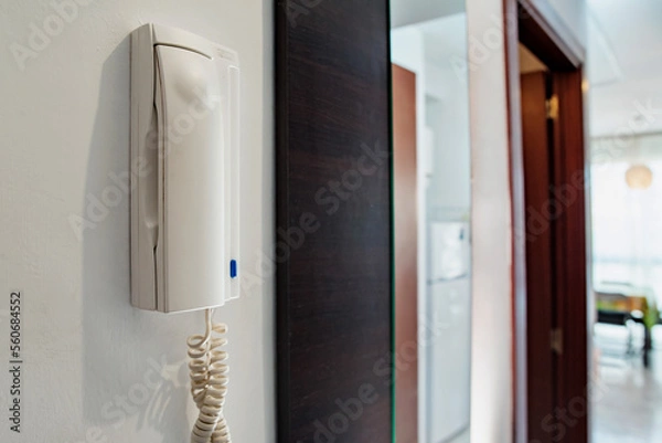 Fototapeta Intercom in the apartment on a white wall close-up