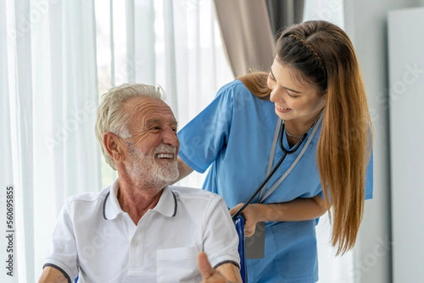 Fototapeta Man being cared for by a private Asian nurse at home suffering from Alzheimer's disease to closely care for elderly patients with copy space on left