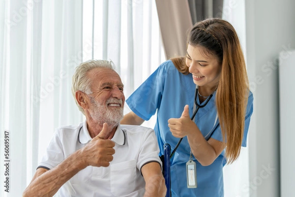 Obraz Man being cared for by a private Asian nurse at home suffering from Alzheimer's disease to closely care for elderly patients with copy space on left