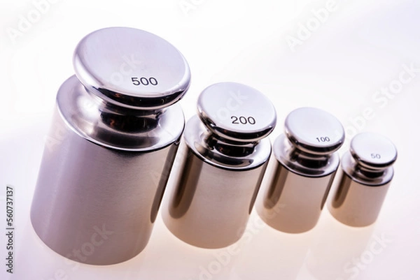 Fototapeta Metallic precision weights of different denominations. Sharpness at the largests