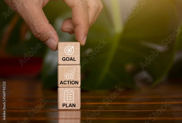 Fototapeta Hand picked cubes have a plan for messages, goals, and actions. Concept of business growth, profit and development for success in 2023.