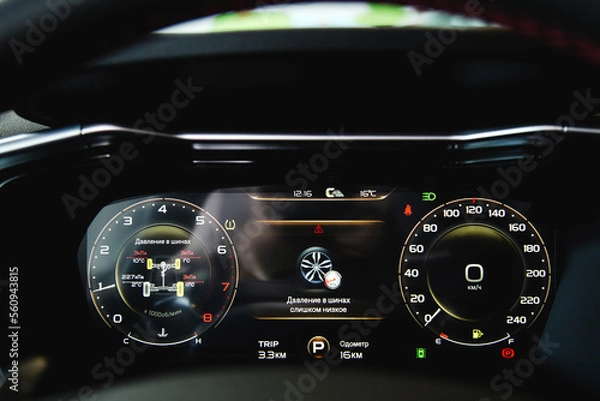 Fototapeta A close-up of a car panel with a speedometer