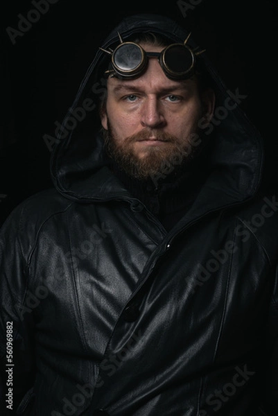 Obraz A man in a hood, wearing vintage steampunk goggles looking at the camera close-up