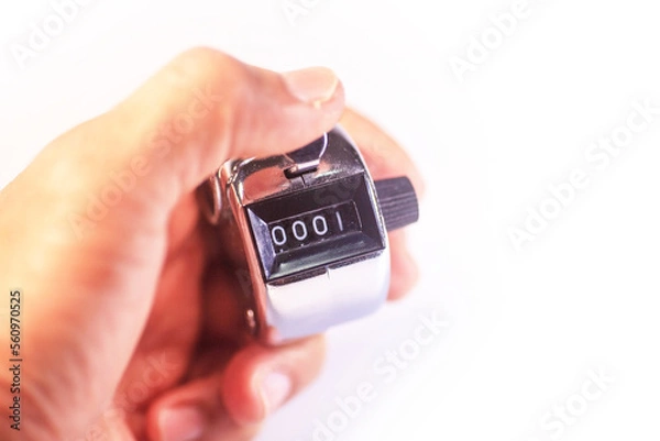 Fototapeta hand holding manual counter on white background