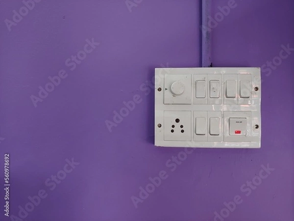 Obraz A white switch board on a violet wall