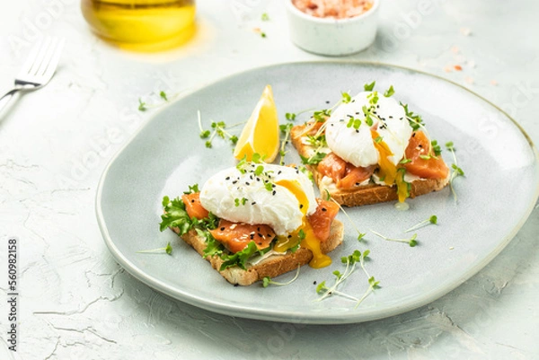 Fototapeta Toast with salmon, poached egg and avocado guacamole, Ketogenic diet. Low carb high fat breakfast. Healthy food concept. place for text, top view