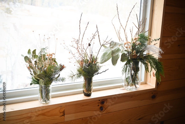 Fototapeta Flower arrangements on a white background in boulder colorado on a white sheet in front of a window - natural and sustainable arrangements