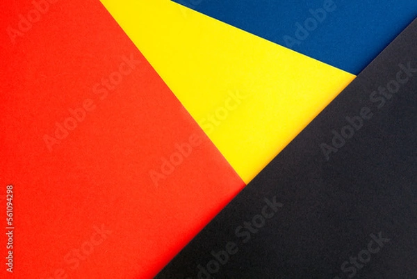 Fototapeta Multicolor background from a cardboard of different colors. Geometrical texture with orange, yellow, blue and brown papers. Copy space.....