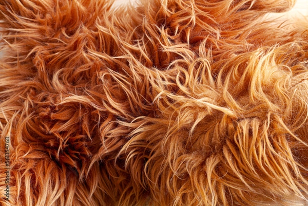 Fototapeta Close up brown synthetic fur, wool texture background. Fluffy and soft faux skin sheep. Light natural, top view. Concept of comfort.