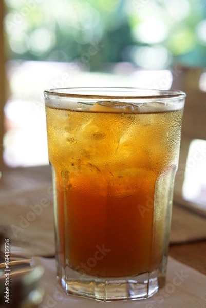 Fototapeta Close up a glass of ice tea with bokeh background.