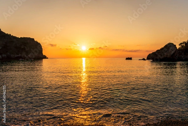 Fototapeta morning or evening landscape with nice beach , a sunrise or sunset in sea with amazing isle with rocks and beautiful clouds on background