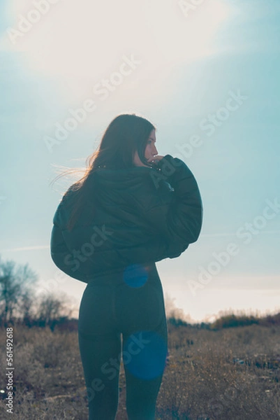 Fototapeta Backlit young model in the field.