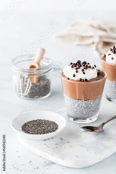 Fototapeta A chocolate mousse chia pudding with chia seeds in front and to the side.