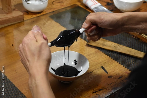 Fototapeta Filtration of Japanese lacquer urushi to remove dust particles - preparation of raw material to create luxurious and glossy traditional lacquerware