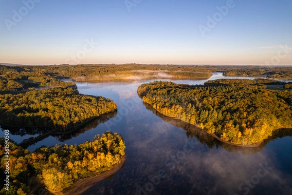 Fototapeta Aerial view of Lac de Saint Pardoux at sunrise in autumn with fog and mirror water