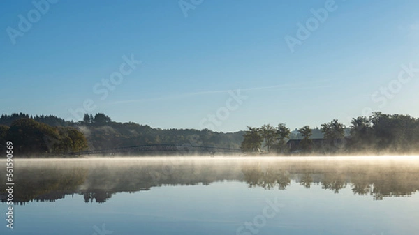 Obraz Passerelle du Lac de Saint Pardoux at sunrise in autumn with fog on the water