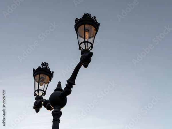 Fototapeta Double streetlights on sky background, minimalist image