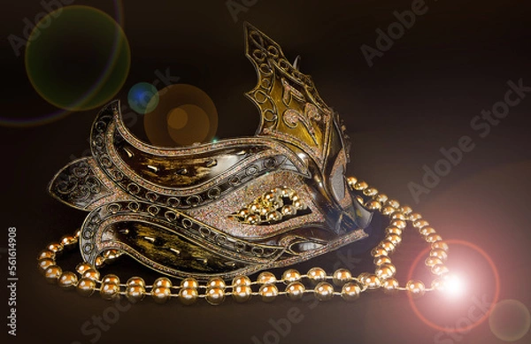 Fototapeta Beautiful carnival mask with beads on a dark background.