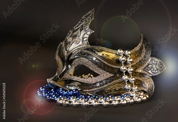 Fototapeta Beautiful carnival mask with beads and sequins on a dark background.