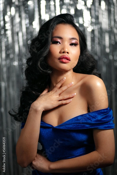 Fototapeta Alluring glamour asian woman with sensual look posing to a camera.	