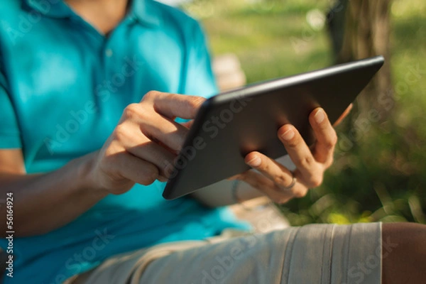 Obraz Man using a digital tablet outdoors