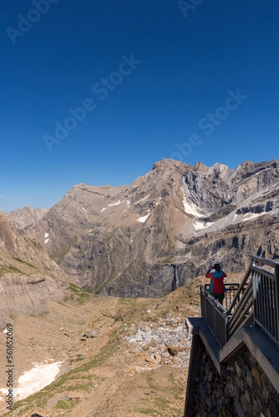 Obraz Young traveler taking photo with a phone over the mountain