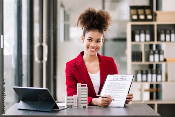 Obraz Real estate broker agent presenting and consult to customer to decision making sign insurance form agreement, home model, concerning mortgage loan offer in office.