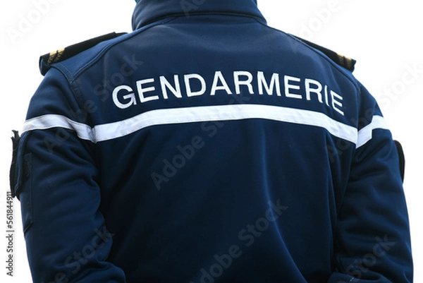 Fototapeta A policeman (gendarme from "gendarmerie") from the back with uniform ensuring security in Paris, France.