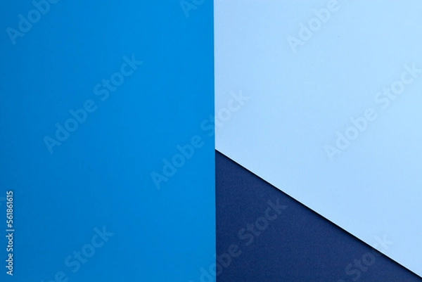 Fototapeta Multilayered colored paper background in blue tones. Abstract geometric flat composition.Empty space on multicolored cardboard. Diagonal, triangules and lines. Top view...
