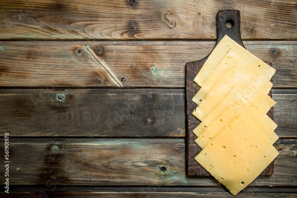 Obraz Thin slices of cheese on the cutting Board.