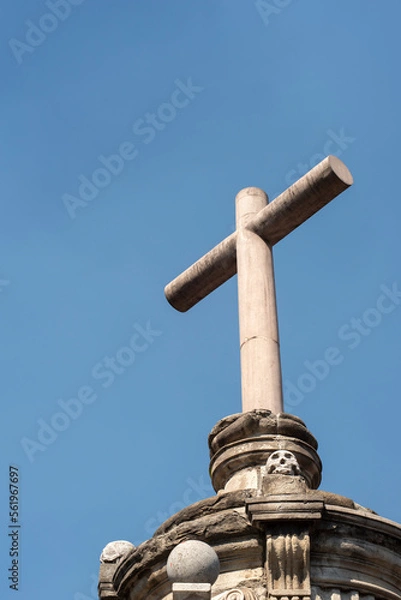 Fototapeta Atrial cross with aztec skulls in its base of the metropolitan cathedral in Mexico City downtown.