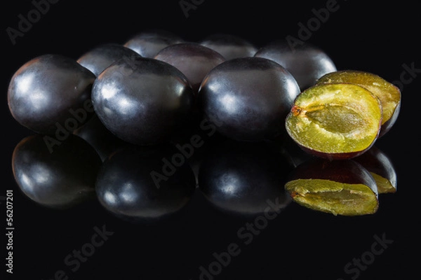 Obraz plums on a black glass