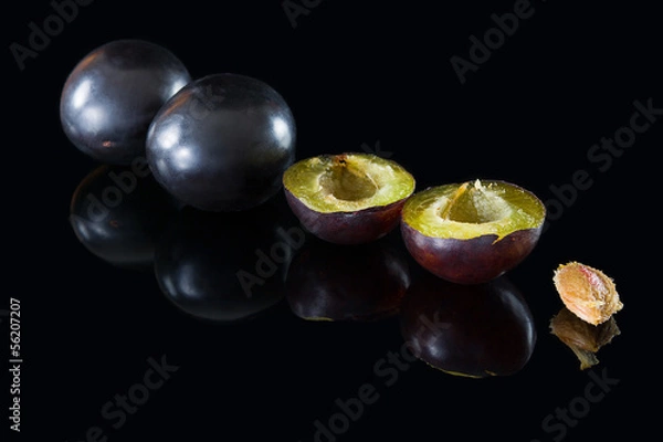 Obraz plums on a black glass