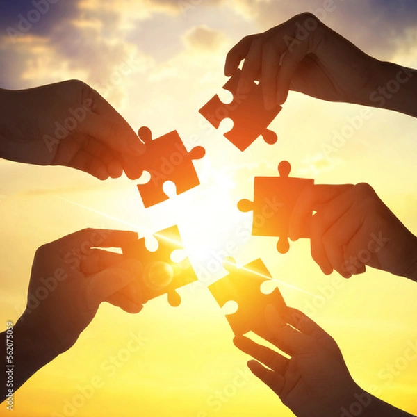 Fototapeta Silhouette five hands holding gear from at sunlight background. Concept of teamwork idea.