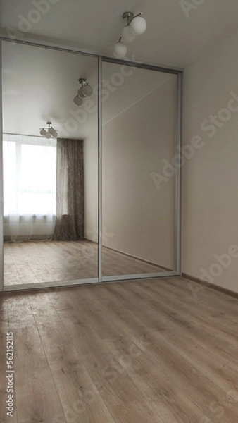 Fototapeta Production of cabinet furniture. Installing a wardrobe. Smart, practical and convenient storage. Repair of the flat. Cleaning and decluttering. Rational use of space in the house and on the balcony.